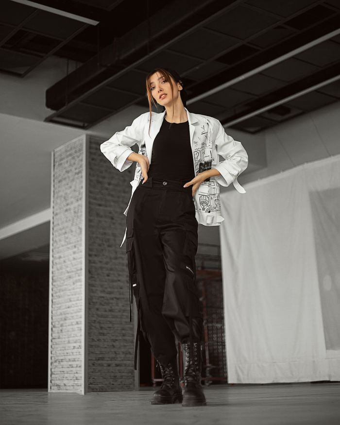 creative-03 Modern style woman in trendy outfit posing inside an urban setting. Chic and confident vibe.